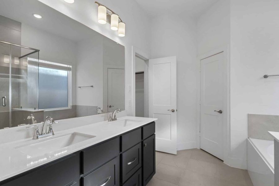 Representative furnished interior of a home built from the Adele by Chesmar Homes in Sunterra, Katy (Image 7).