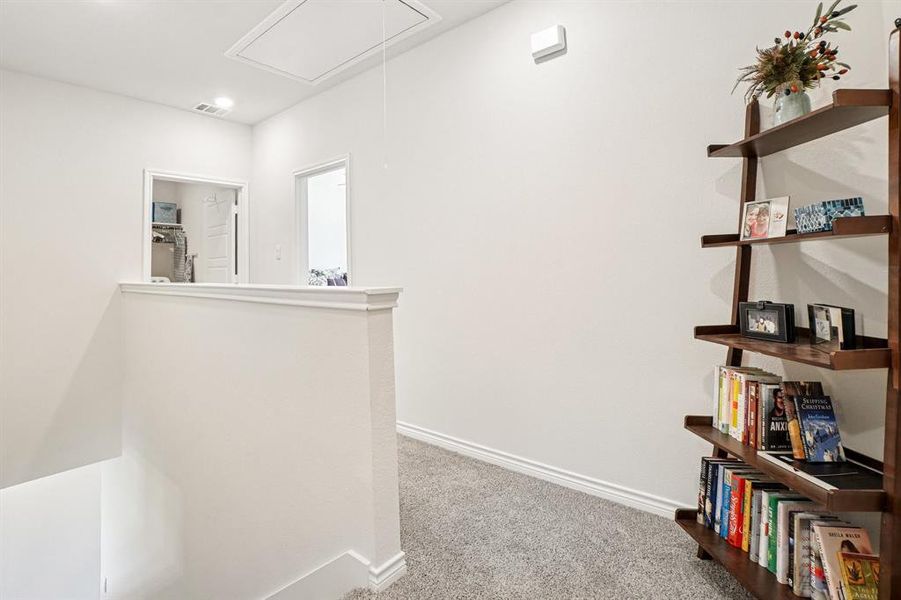 Hall featuring attic access, carpet flooring, and an upstairs landing Hall featuring attic access, carpet flooring, and an upstairs landing