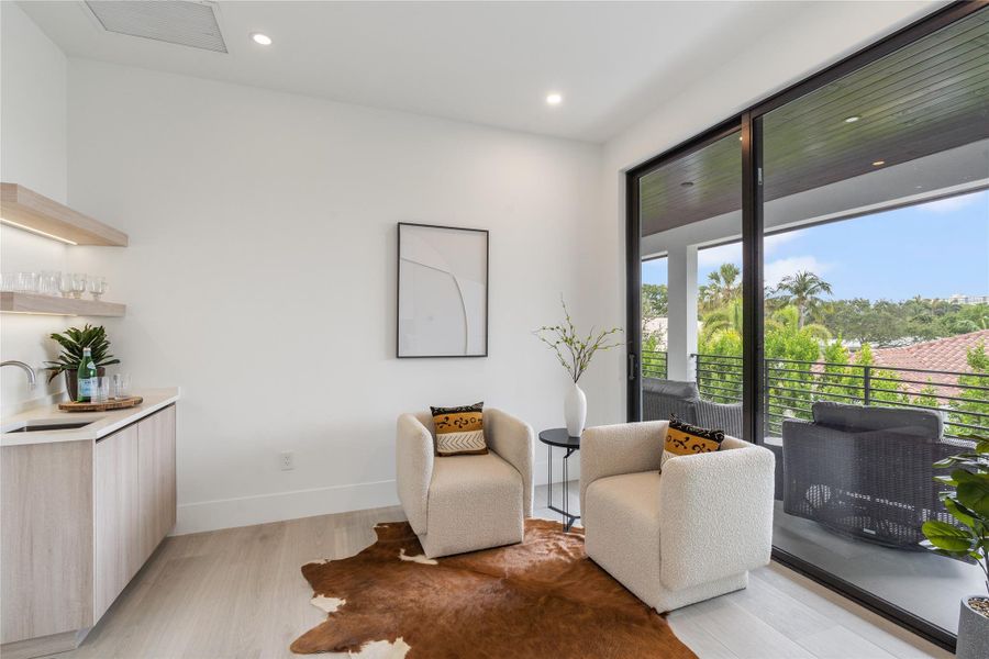 Seating area with wet  bar adjacent to the primary suite