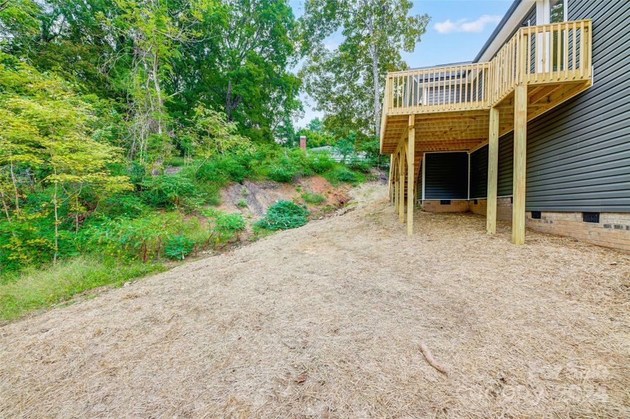 Back Deck overlooks private, wooded Backyard of the 0.755 acre lot