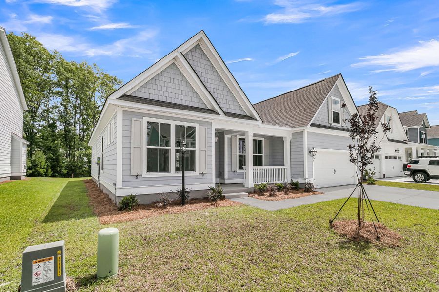 Front exterior of a new home in Tidewater at Lakes of Cane Bay, Summerville, SC, highlighting curb appeal (Image 2). Front exterior of a new home in Tidewater at Lakes of Cane Bay, Summerville, SC, highlighting curb appeal (Image 2).