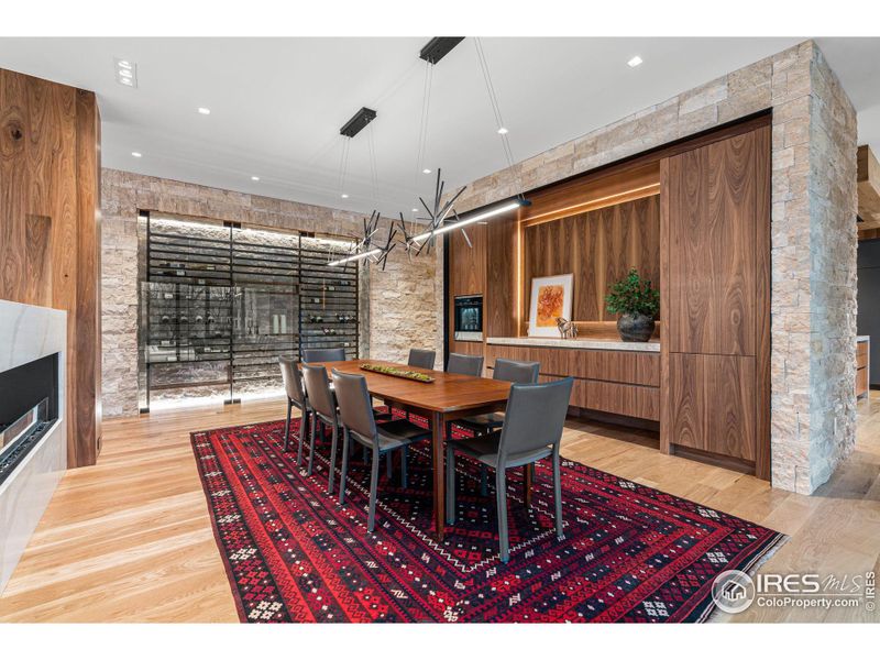 Jerusalem limestone accent wall with 368 bottle wine rack and built-in walnut buffet with exquisite Shiloh cabinets and Pental Quartz slab counter.  Featuring a Dacor 4-bottle chilled wine dispenser ensuring every pour is effortless.