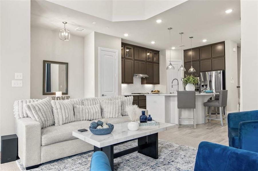 Tiled living room with sink and a chandelier