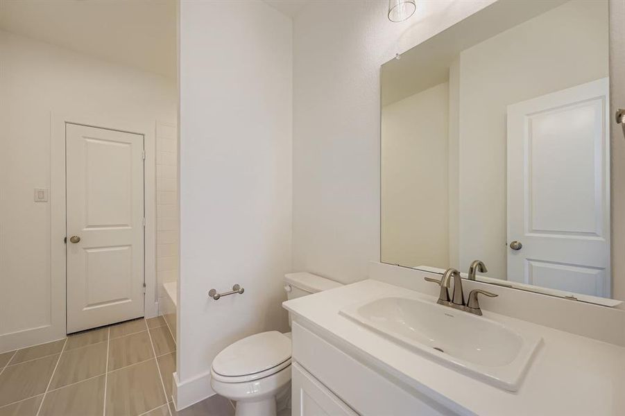 Full bathroom with vanity, light tile patterned floors, and bathing tub / shower combination Full bathroom with vanity, light tile patterned floors, and bathing tub / shower combination