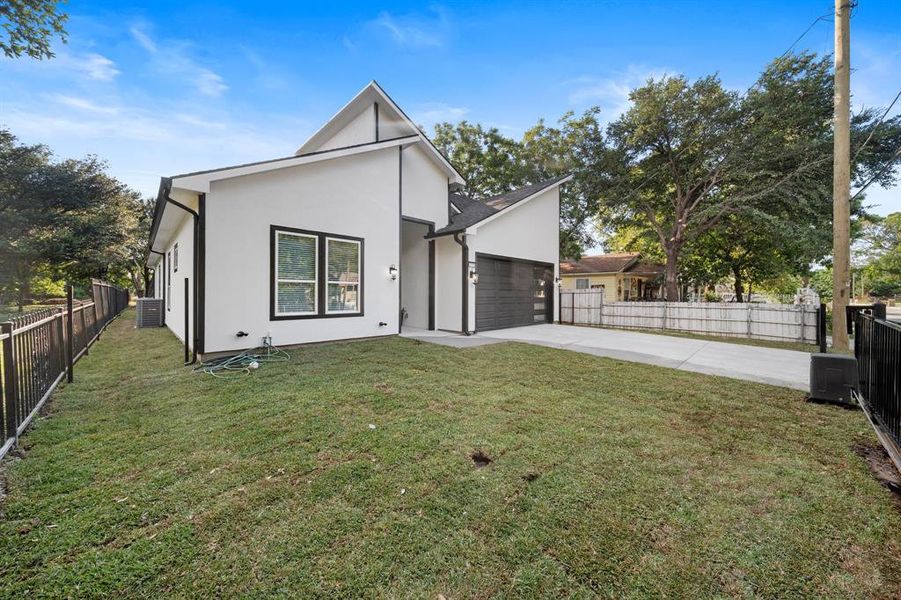 Back of property featuring a yard and central AC