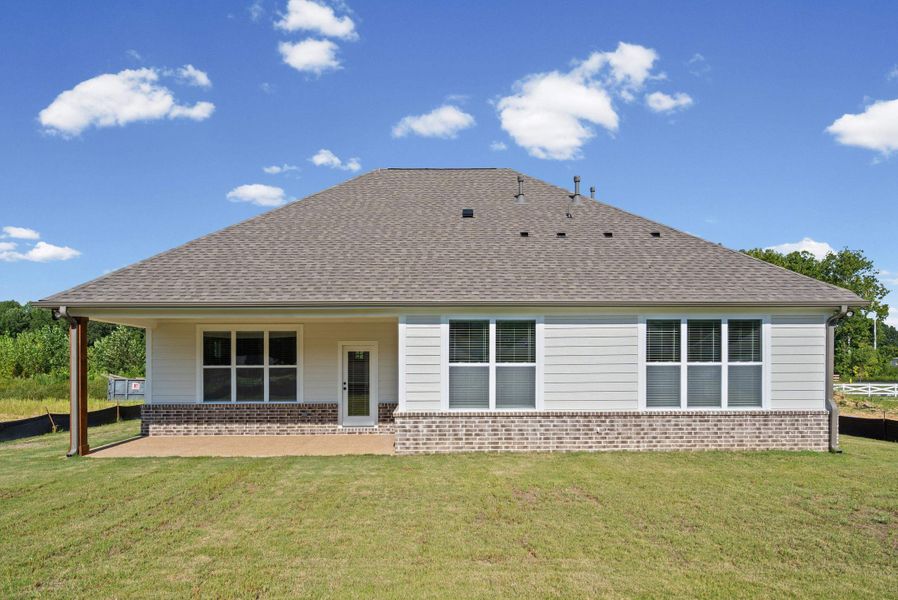 Rear exterior featuring a covered patio with a stained wood column, multiple windows, a rear entry door, and a brick and siding facade Rear exterior featuring a covered patio with a stained wood column, multiple windows, a rear entry door, and a brick and siding facade