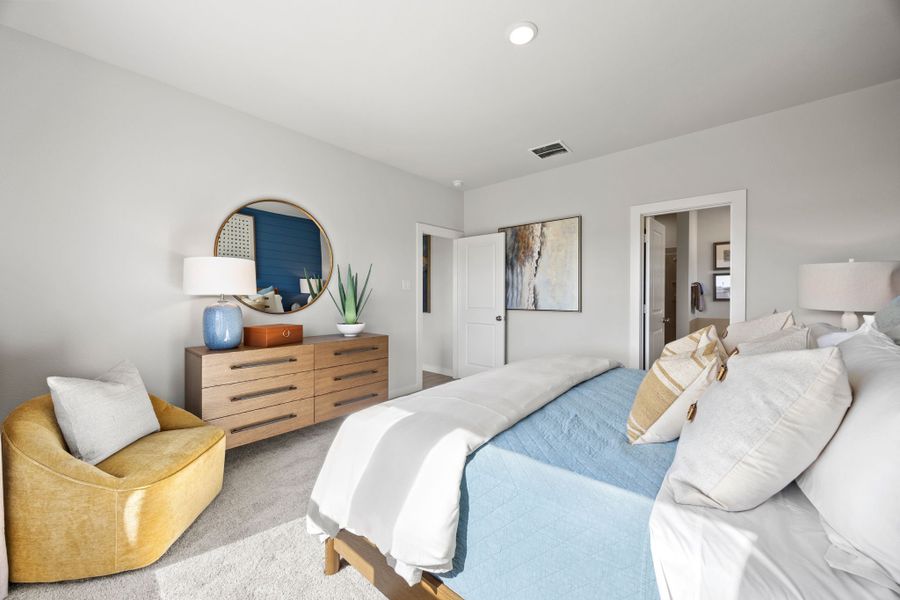 A bedroom with a bed and a chair. A bedroom with a bed and a chair.