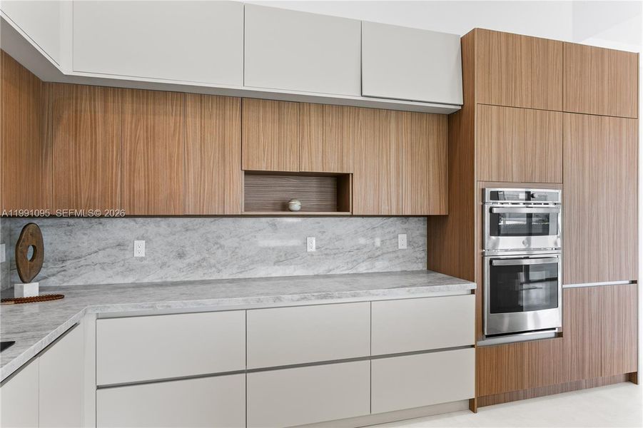 Large pantry & premium GE appliances including wall oven, microwave, electric cooktop, dishwasher, refrigerator and freezer, plus a large sink with black fixtures Large pantry & premium GE appliances including wall oven, microwave, electric cooktop, dishwasher, refrigerator and freezer, plus a large sink with black fixtures