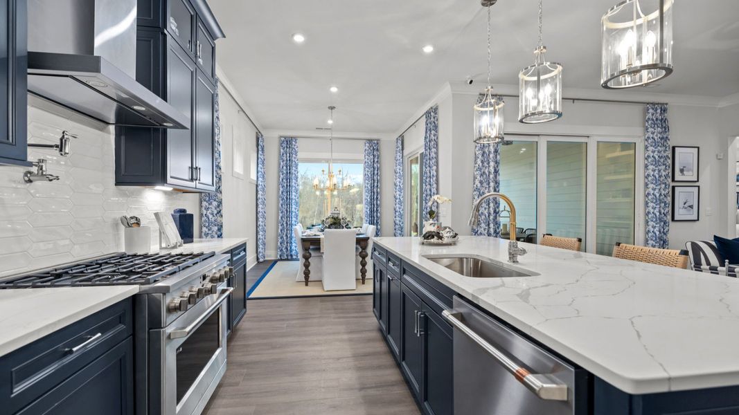 The Adventurer Plan by DBR Homes kitchen with blue cabinets and modern features in Fort Mill, SC.