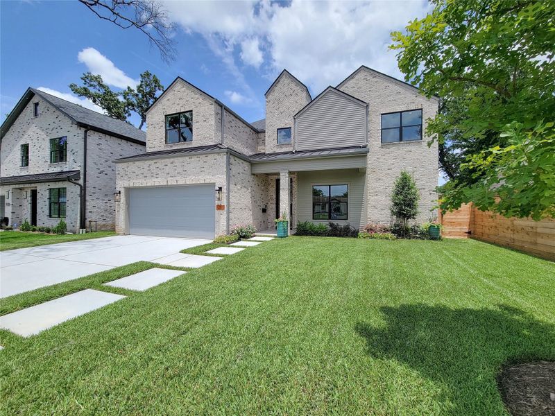 Stunning front elevation featuring timeless architecture, enhanced by beautifully designed landscaping and inviting curb appeal. Lush greenery, accent plantings, and a thoughtfully planned exterior create a warm and welcoming first impression. Stunning front elevation featuring timeless architecture, enhanced by beautifully designed landscaping and inviting curb appeal. Lush greenery, accent plantings, and a thoughtfully planned exterior create a warm and welcoming first impression.