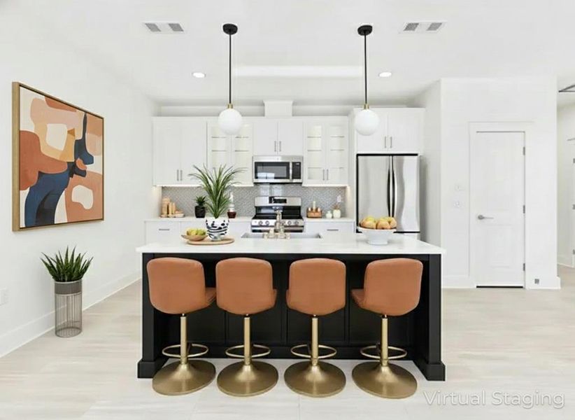 Kitchen with dark cabinetry, stainless steel appliances, pendant lighting, tasteful backsplash, and a kitchen breakfast bar Kitchen with dark cabinetry, stainless steel appliances, pendant lighting, tasteful backsplash, and a kitchen breakfast bar