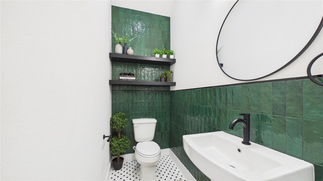 The powder room is artfully designed with a striking floor-to-ceiling statement tile wall, custom wood shelving, and a full-height backsplash.