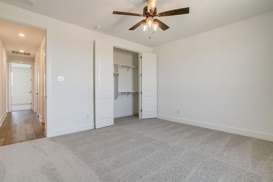 Unfurnished bedroom featuring carpet, ceiling fan, a closet, and recessed lighting Unfurnished bedroom featuring carpet, ceiling fan, a closet, and recessed lighting