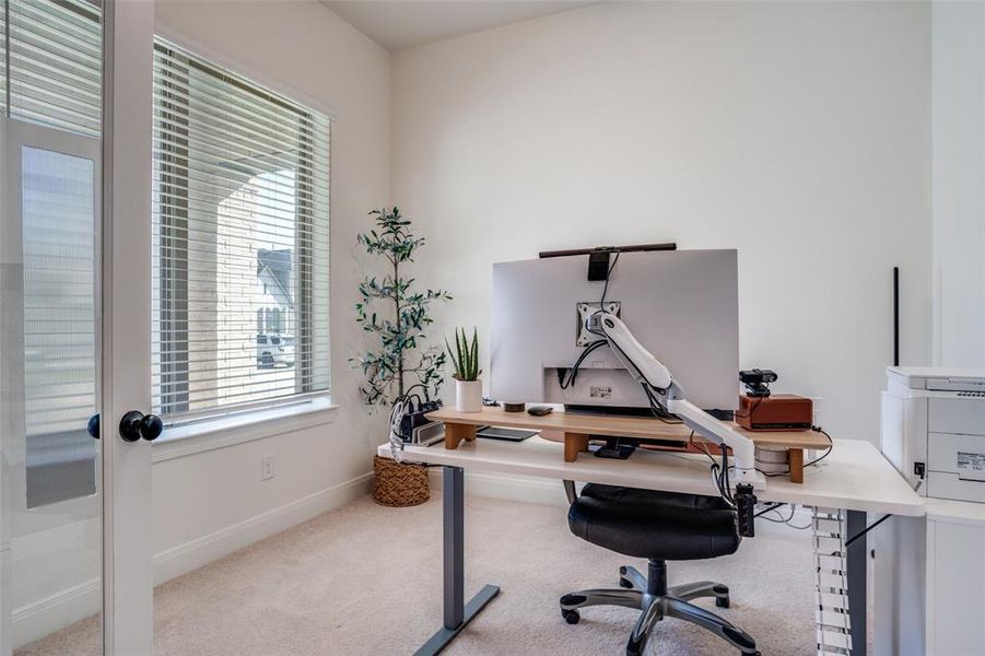 Office featuring light colored carpet and baseboards
