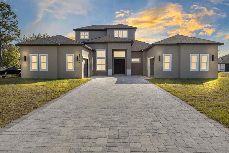 No need to wait for new construction—this stunning 2024-built home sits on 1.74 acres in the highly sought-after Cape Orlando Estates community!