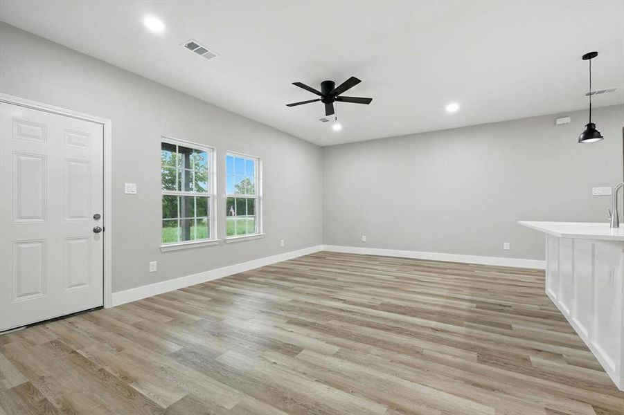 Unfurnished living room featuring light wood finished floors, recessed lighting, and ceiling fan Unfurnished living room featuring light wood finished floors, recessed lighting, and ceiling fan