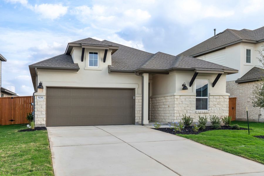 Front exterior of a new home in Lariat, Liberty Hill, TX, highlighting curb appeal (Image 22).