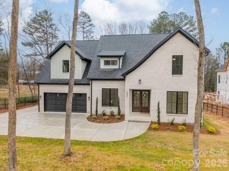 Front exterior of a new home in , Weddington, NC, highlighting curb appeal (Image 25).