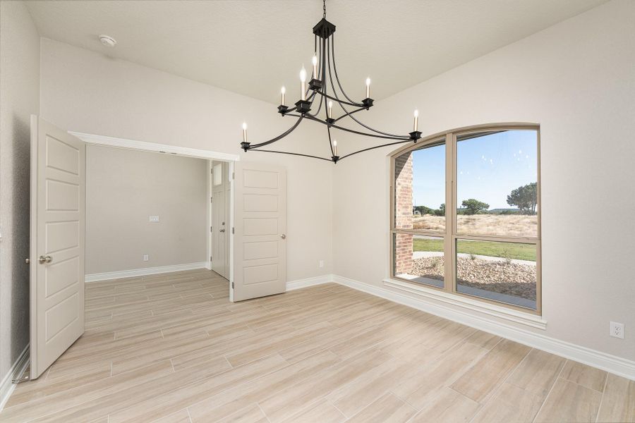 Unfurnished dining area featuring wood tiled floors and a chandelier Unfurnished dining area featuring wood tiled floors and a chandelier