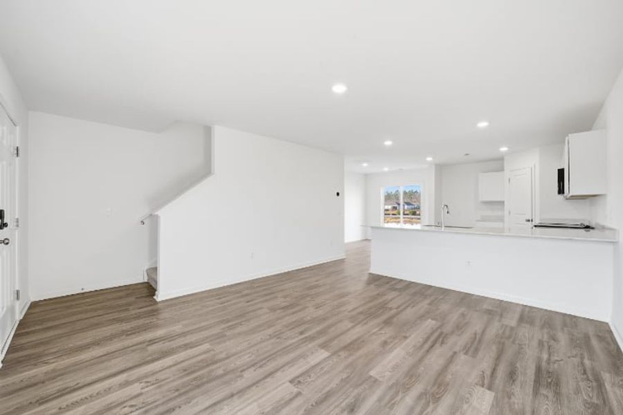 A room with white walls and wood floors.