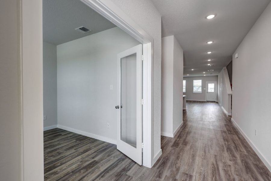 A hallway with white doors.
