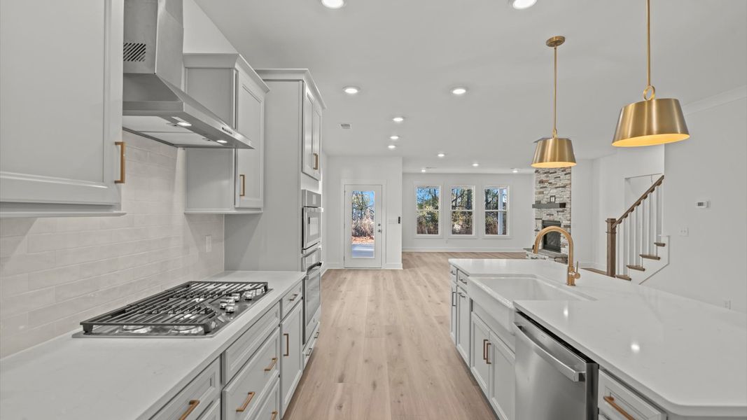 First-class kitchen with a spacious 8-foot island perfect for entertaining beneath designer pendant lighting