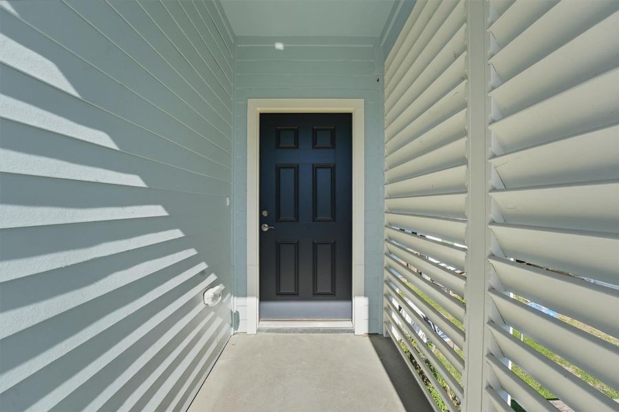 The covered entry creates a welcoming transition into the home, featuring a private front approach that adds convenience for owners and guests alike.