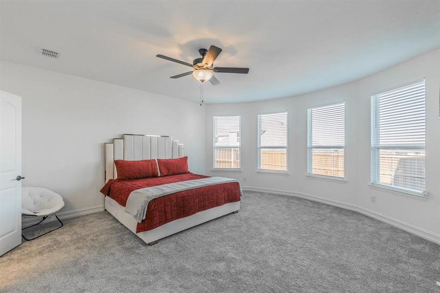 Bedroom with light colored carpet and ceiling fan