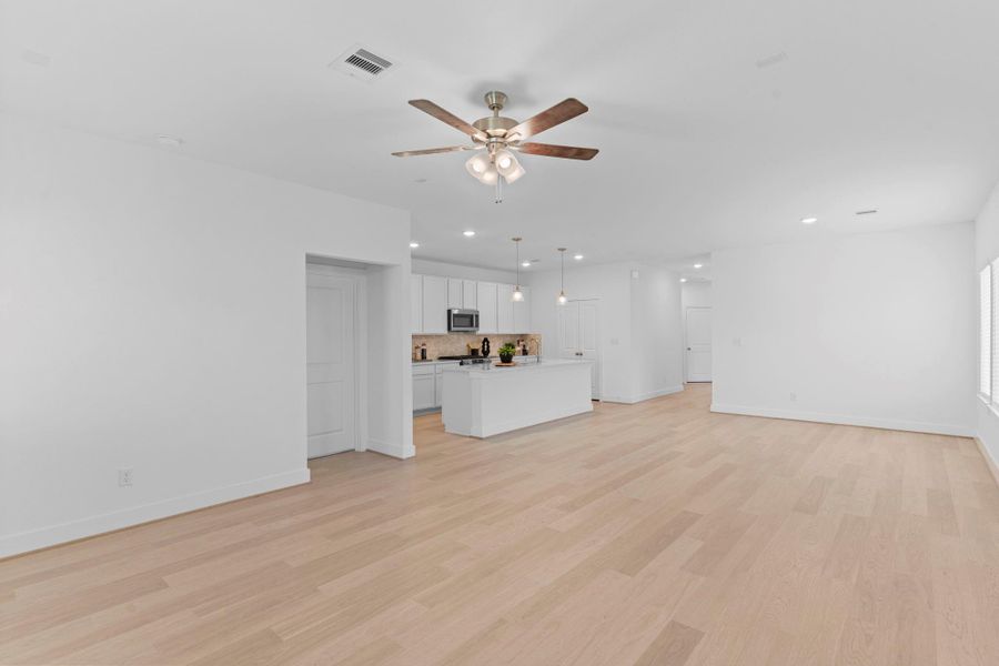 This bright and airy family room feels like the heart of the home! Wide wood-look tile floors, large windows, and a modern ceiling fan create a relaxing space ideal for gatherings, movie nights, or quiet evenings at home. **Image Representative of Plan Only and May Vary as Built**.