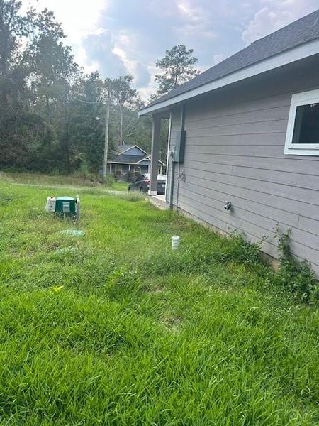Exterior details and patio area of a home in Frontier Lakes, Willis (Image 21). Exterior details and patio area of a home in Frontier Lakes, Willis (Image 21).