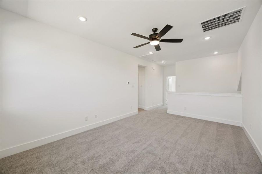 Spare room with light colored carpet, recessed lighting, a ceiling fan, and attic access Spare room with light colored carpet, recessed lighting, a ceiling fan, and attic access