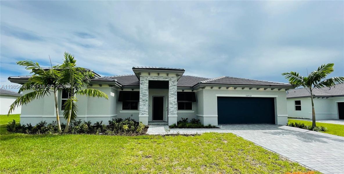 Front exterior of a new home in , Homestead, FL, highlighting curb appeal (Image 13).