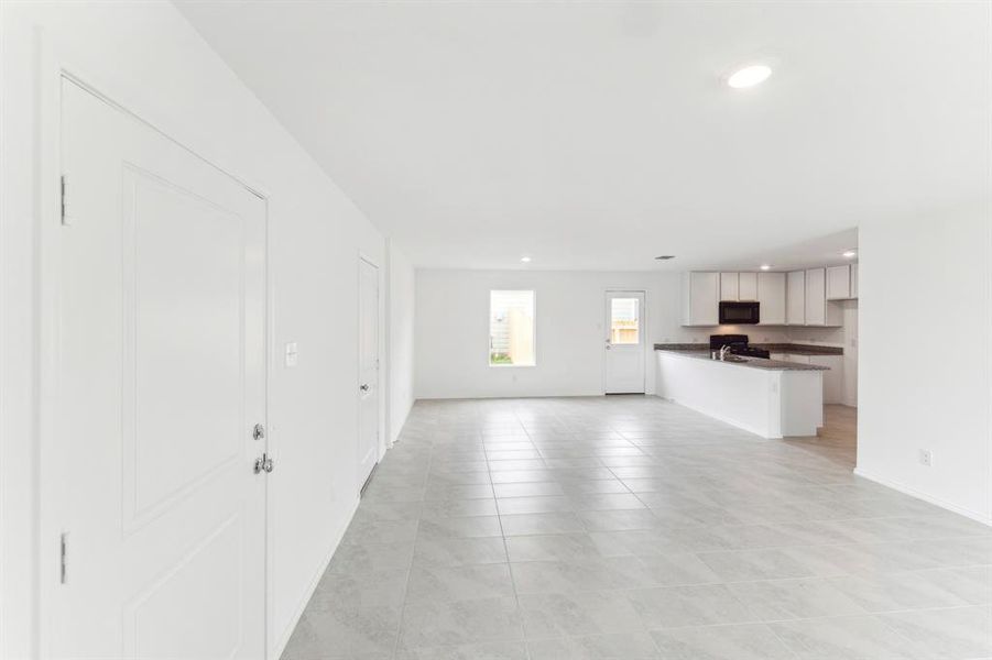 Unfurnished living room featuring light tile patterned floors