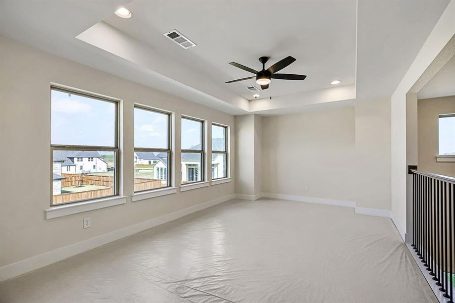 Empty room with ceiling fan, recessed lighting, and a tray ceiling Empty room with ceiling fan, recessed lighting, and a tray ceiling