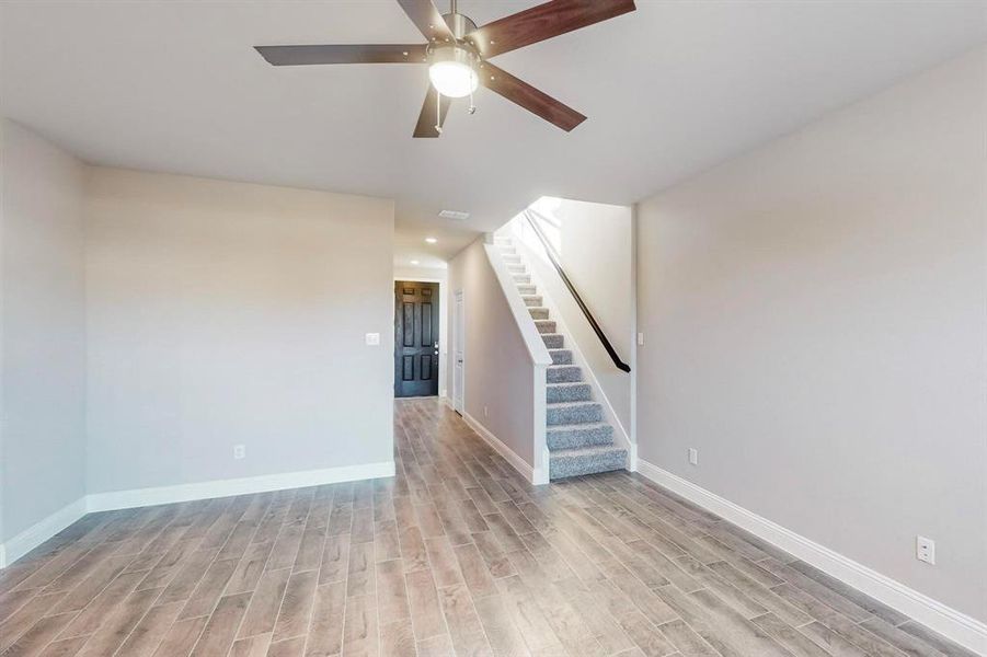 Empty room featuring ceiling fan and light hardwood / wood-style flooring