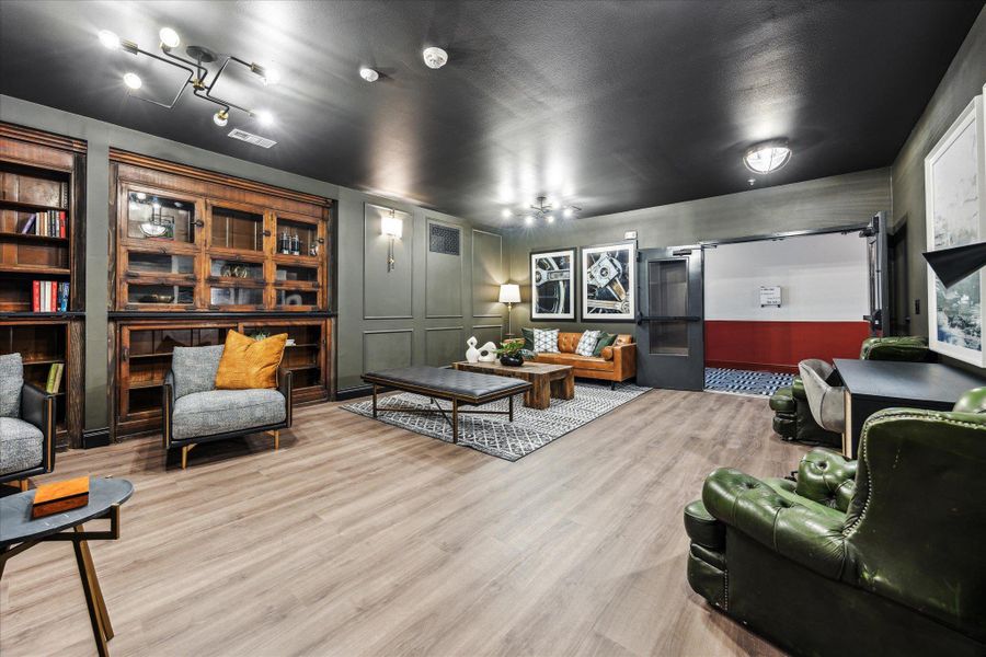 Hardwood floors and a sophisticated built-in bookcase define this inviting communal space. Hardwood floors and a sophisticated built-in bookcase define this inviting communal space.