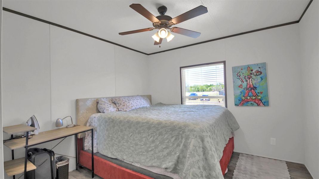 Bedroom featuring ceiling fan and crown molding