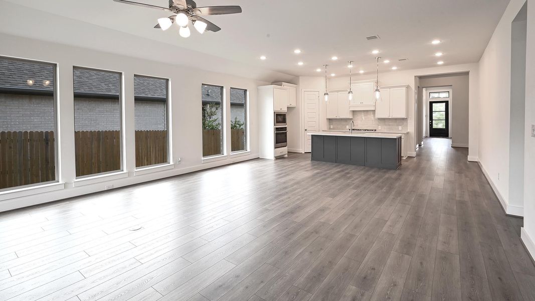 Unfurnished living room featuring recessed lighting, dark wood-style floors, and ceiling fan Unfurnished living room featuring recessed lighting, dark wood-style floors, and ceiling fan