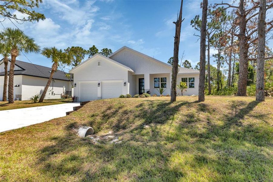 Front exterior of a new home in , Port Charlotte, FL, highlighting curb appeal (Image 1).