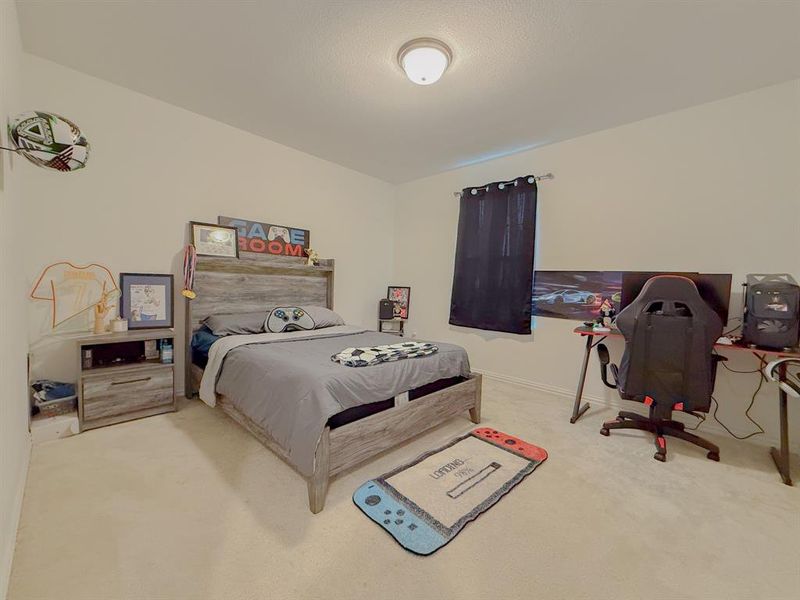 Bedroom with baseboards and carpet flooring