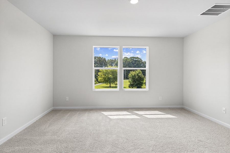 A room with a window and a rug in it.