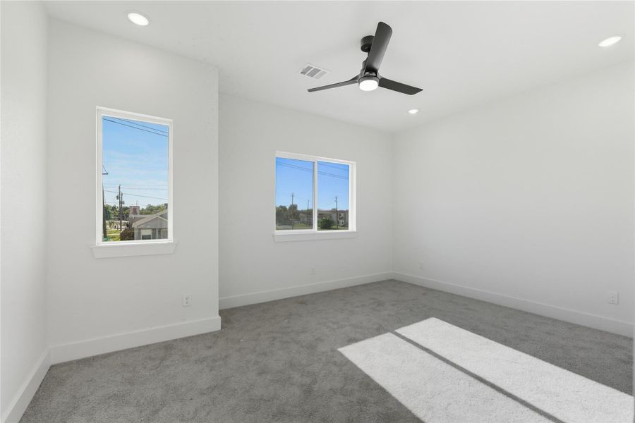 The spacious primary bedroom offers a calm and comfortable space, complete with plush carpeting and plenty of natural light from the multiple windows. A modern ceiling fan and recessed lighting add both style and function, creating the perfect balance of coziness and contemporary design. This restful space is ideal for winding down at the end of your day! The spacious primary bedroom offers a calm and comfortable space, complete with plush carpeting and plenty of natural light from the multiple windows. A modern ceiling fan and recessed lighting add both style and function, creating the perfect balance of coziness and contemporary design. This restful space is ideal for winding down at the end of your day!