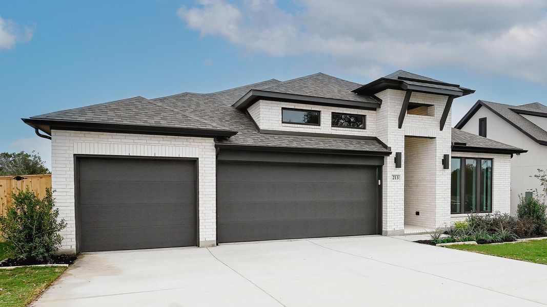 Front exterior of a new home in La Cima 60', San Marcos, TX, highlighting curb appeal (Image 19). Front exterior of a new home in La Cima 60', San Marcos, TX, highlighting curb appeal (Image 19).