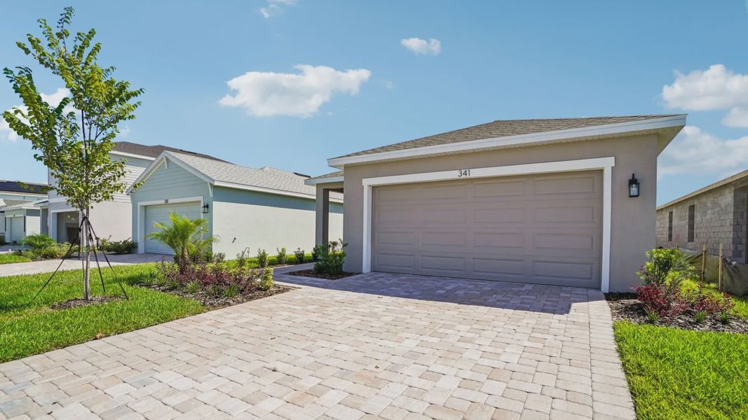 Front exterior of a new home in Willowbrook North, Winter Haven, FL, highlighting curb appeal (Image 21).