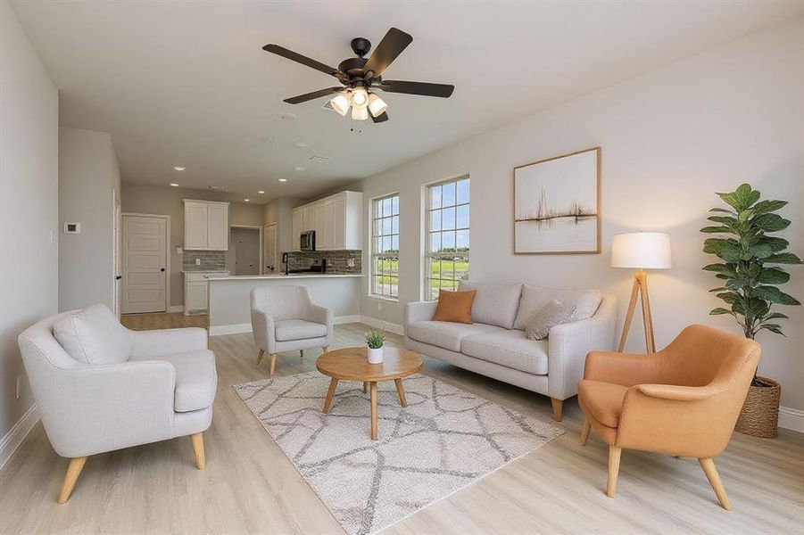 Living area featuring light wood-style flooring, recessed lighting, and a ceiling fan