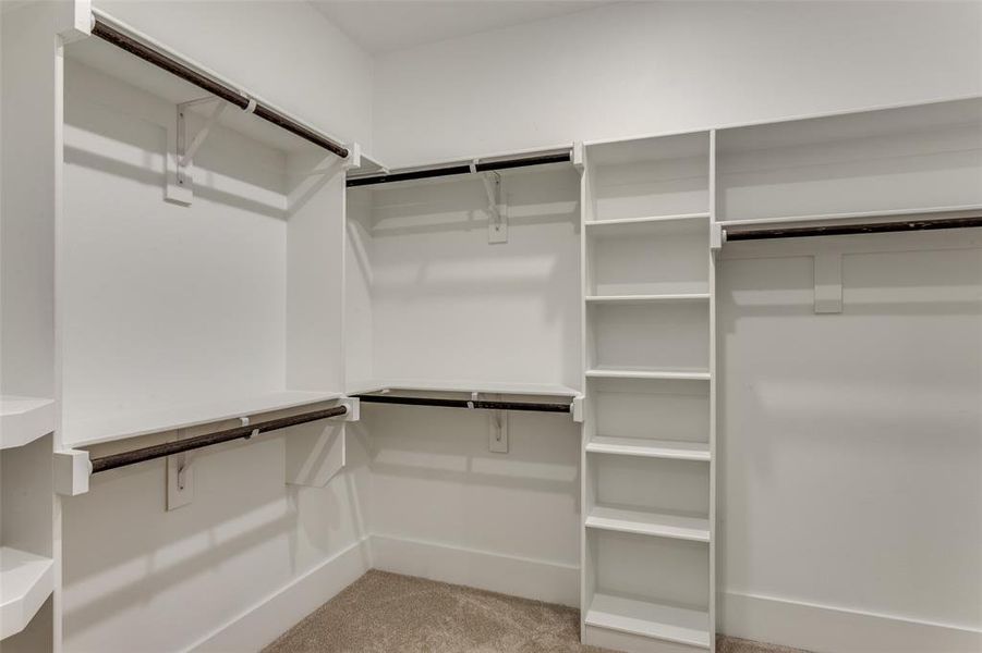 Spacious closet featuring light colored carpet Spacious closet featuring light colored carpet