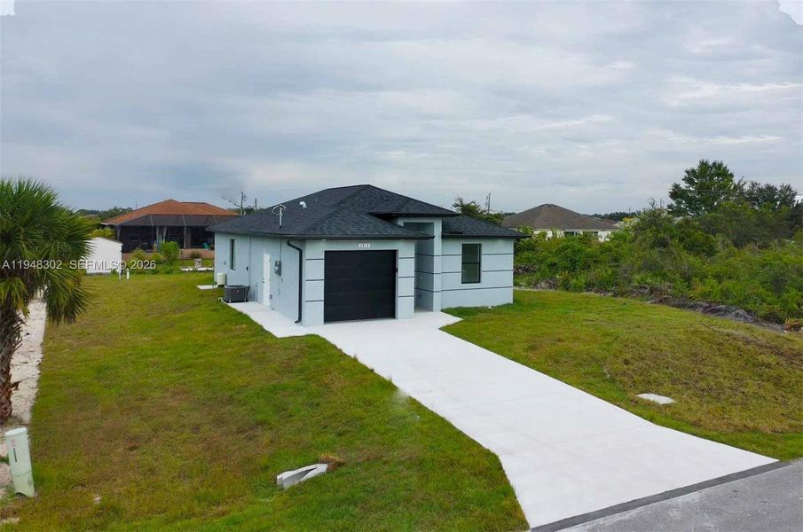 Front exterior of a new home in , Lehigh Acres, FL, highlighting curb appeal (Image 22).