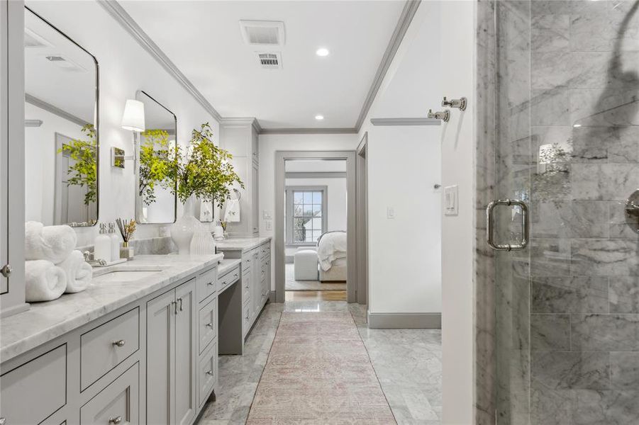 Ensuite bathroom featuring marble finish floor, a shower stall, connected bathroom, and crown molding