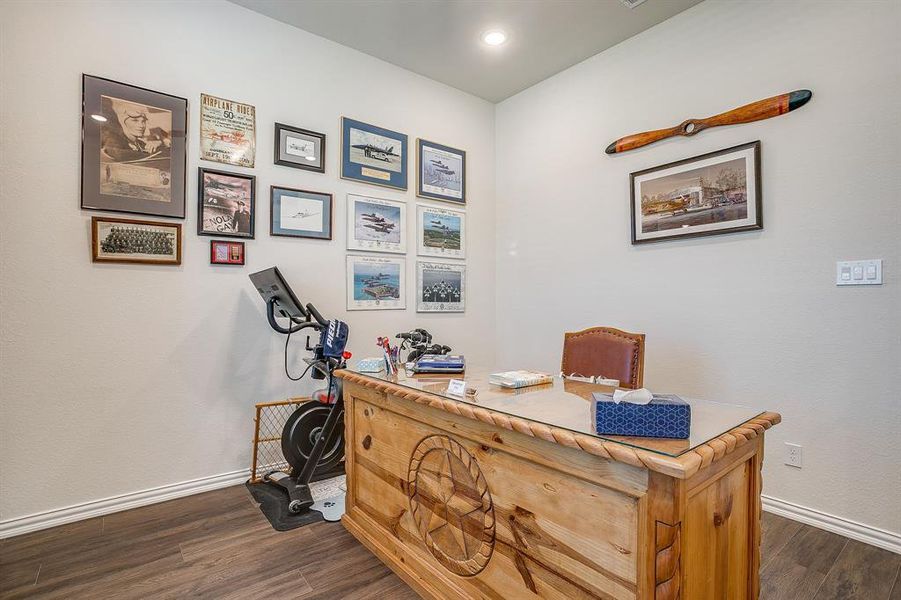 Office with dark wood-style flooring and baseboards Office with dark wood-style flooring and baseboards