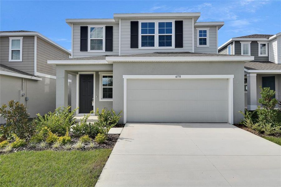 Front exterior of a new home in Seasons at Scenic Terrace, Lake Hamilton, FL, highlighting curb appeal (Image 1). Front exterior of a new home in Seasons at Scenic Terrace, Lake Hamilton, FL, highlighting curb appeal (Image 1).